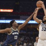 
              Minnesota Timberwolves center Karl-Anthony Towns (32) shoots against Memphis Grizzlies forward Jaren Jackson Jr. (13) in the second half during Game 5 of a first-round NBA basketball playoff series Tuesday, April 26, 2022, in Memphis, Tenn. (AP Photo/Brandon Dill)
            
