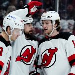 
              New Jersey Devils left wing Tomas Tatar, middle, celebrates his goal against the Arizona Coyotes with left wing Jesper Bratt (63) and center Dawson Mercer (18) during the second period of an NHL hockey game Tuesday, April 12, 2022, in Glendale, Ariz. (AP Photo/Ross D. Franklin)
            