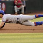 
              New York Mets' Jeff McNeil dives into third with an RBI triple against the Arizona Diamondbacks during the fifth inning of a baseball game, Saturday, April 23, 2022, in Phoenix. (AP Photo/Matt York)
            