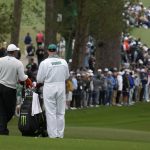 
              Tiger Woods waits with his caddie Joe LaCava to hit on the second fairway during the third round at the Masters golf tournament on Saturday, April 9, 2022, in Augusta, Ga. (AP Photo/Charlie Riedel)
            
