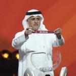 
              Former Qatari soccer international Adel Ahmed MalAllah holds up the name of Iran during the 2022 soccer World Cup draw at the Doha Exhibition and Convention Center in Doha, Qatar, Friday, April 1, 2022. (AP Photo/Hassan Ammar)
            