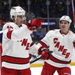 
              Carolina Hurricanes center Seth Jarvis (24) celebrates with Sebastian Aho (20) after scoring a goal against the New York Islanders during the first period of an NHL hockey game, Sunday, April 24, 2022, in New York. (AP Photo/Noah K. Murray)
            