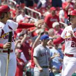 
              St. Louis Cardinals' Nolan Arenado, left, and Corey Dickerson (25) celebrate after scoring during the fourth inning of a baseball game against the New York Mets Wednesday, April 27, 2022, in St. Louis. (AP Photo/Jeff Roberson)
            