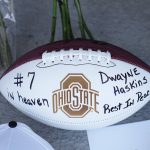 
              Mary Ellen Curzon-Price of Columbus left this football, roses, and other items at a makeshift memorial for former Ohio State football player and Pittsburgh Steelers quarterback Dwayne Haskins Jr., at a memorial at Ohio Stadium on the campus of Ohio State University, Sunday, April 10, 2022. Haskins, 24, was killed early Saturday morning when he was hit by a dump truck while he was walking on Interstate 595 in South Florida. Mary's husband, Gary Price, and son, Ian Moses, 28, are graduates of Ohio State. Her son, Brett Price, 22, is currently a junior at the college. (Fred Squillante/The Columbus Dispatch via AP)
            