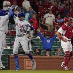 
              New York Mets' Brandon Nimmo (9) is congratulated by teammate Dominic Smith (2) after hitting a two-run home run as St. Louis Cardinals catcher Andrew Knizner, right, stands at the plate during the ninth inning of a baseball game Monday, April 25, 2022, in St. Louis. (AP Photo/Jeff Roberson)
            