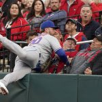 
              New York Mets first baseman Pete Alonso falls against netting as he catches a foul ball by St. Louis Cardinals' Paul Goldschmidt for an out during the first inning of a baseball game Monday, April 25, 2022, in St. Louis. (AP Photo/Jeff Roberson)
            