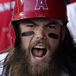 
              Los Angeles Angels' Brandon Marsh yells in the dugout after hitting a three-run home run during the first inning of a baseball game against the Miami Marlins Monday, April 11, 2022, in Anaheim, Calif. (AP Photo/Mark J. Terrill)
            