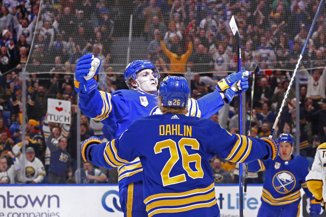 Buffalo Sabres right wing Tage Thompson, left, celebrates his goal with defenseman Rasmus Dahlin (2...