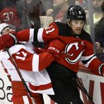 
              New Jersey Devils left wing Andreas Johnsson (11) holds off Detroit Red Wings defenseman Filip Hronek (17) during the third period of an NHL hockey game Sunday, April 24, 2022, in Newark, N.J. (AP Photo/Bill Kostroun)
            