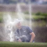 
              Jordan Spieth watches his shot out of the bunker on the 18th hole from behind a cloud of sand during a one-hole playoff with Patrick Cantlay at the RBC Heritage golf tournament, Sunday, April 17, 2022, in Hilton Head Island, S.C. (AP Photo/Stephen B. Morton)
            