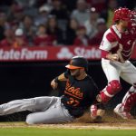 
              Baltimore Orioles' Anthony Bemboom (37) scores past Los Angeles Angels catcher Max Stassi on a sacrifice fly by Trey Mancini during the seventh inning of a baseball game Saturday, April 23, 2022, in Anaheim, Calif. (AP Photo/Marcio Jose Sanchez)
            