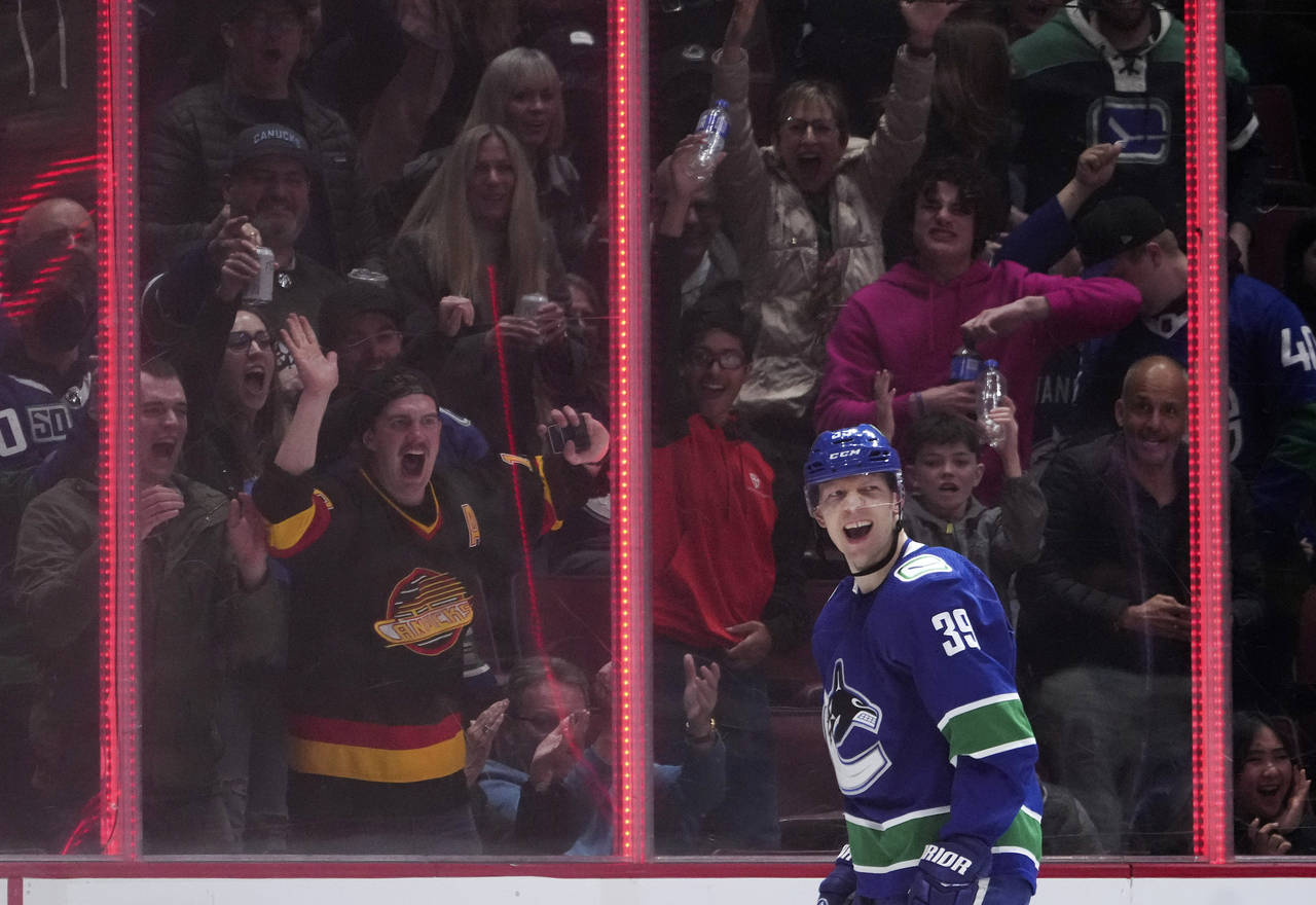 Vancouver Canucks' Alex Chiasson and fans celebrate his goal against the San Jose Sharks during the...