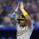 
              Oakland Athletics' Tony Kemp celebrates as he scores on a hit by Chad Pinder against the Toronto Blue Jays during the sixth inning of a baseball game Friday, April 15, 2022, in Toronto. (Frank Gunn/The Canadian Press via AP)
            