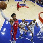 
              Philadelphia 76ers' Tobias Harris, left, goes up for the dunk as Indiana Pacers' Buddy Hield, center and Terry Taylor, right, look on during the first half of an NBA basketball game, Saturday, April 9, 2022, in Philadelphia. The 76ers won 133-120. (AP Photo/Chris Szagola)
            
