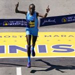 
              Peres Jepchirchir, of Kenya, breaks the tape to win the women's division of the Boston Marathon, Monday, April 18, 2022, in Boston. (AP Photo/Charles Krupa)
            
