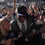 
              Alabama offensive tackle Evan Neal celebrates with fans after being picked by the New York Giants with the seventh pick of the NFL football draft Thursday, April 28, 2022, in Las Vegas. (AP Photo/Jae C. Hong)
            