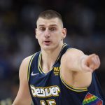 
              Denver Nuggets center Nikola Jokic gestures after hitting a 3-point basket against the Golden State Warriors in the first half of Game 4 of an NBA basketball first-round Western Conference playoff series Sunday, April 24, 2022, in Denver. (AP Photo/David Zalubowski)
            