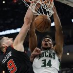 
              Milwaukee Bucks' Giannis Antetokounmpo dunks over Chicago Bulls' Nikola Vucevic during the first half of Game 1 of their first round NBA playoff basketball game Sunday, April 17, 2022, in Milwaukee. (AP Photo/Morry Gash)
            
