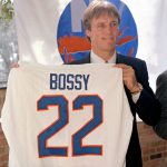 
              FILE - Mike Bossy holds his New York Islanders uniform up at a news conference in New York, Oct. 24, 1988. Bossy, one of hockey’s most prolific goal-scorers and a star for the New York Islanders during their 1980s dynasty, died Thursday, April 14, 2022, after a battle with lung cancer. He was 65.  (AP Photo/Gerald Herbert, File)
            