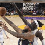 
              Denver Nuggets center DeMarcus Cousins, left, shoots as Los Angeles Lakers forward Wenyen Gabriel defends during the first half of an NBA basketball game Sunday, April 3, 2022, in Los Angeles. (AP Photo/Mark J. Terrill)
            