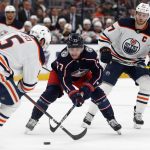 
              Columbus Blue Jackets forward Justin Danforth, center, chases the puck between Edmonton Oilers defenseman Cody Ceci, left, and forward Connor McDavid during the second period an NHL hockey game in Columbus, Ohio, Sunday, April 24, 2022. (AP Photo/Paul Vernon)
            