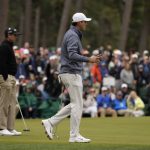 
              Scottie Scheffler, right, waves after a birdie on the sixth green during the third round at the Masters golf tournament on Saturday, April 9, 2022, in Augusta, Ga. Left is Charl Schwartzel, of South Africa. (AP Photo/Jae C. Hong)
            