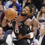 
              Los Angeles Clippers guard Paul George (13) is fouled by Minnesota Timberwolves forward Anthony Edwards during the second quarter during an NBA basketball game Tuesday, April 12, 2022, in Minneapolis. (AP Photo/Andy Clayton-King)
            