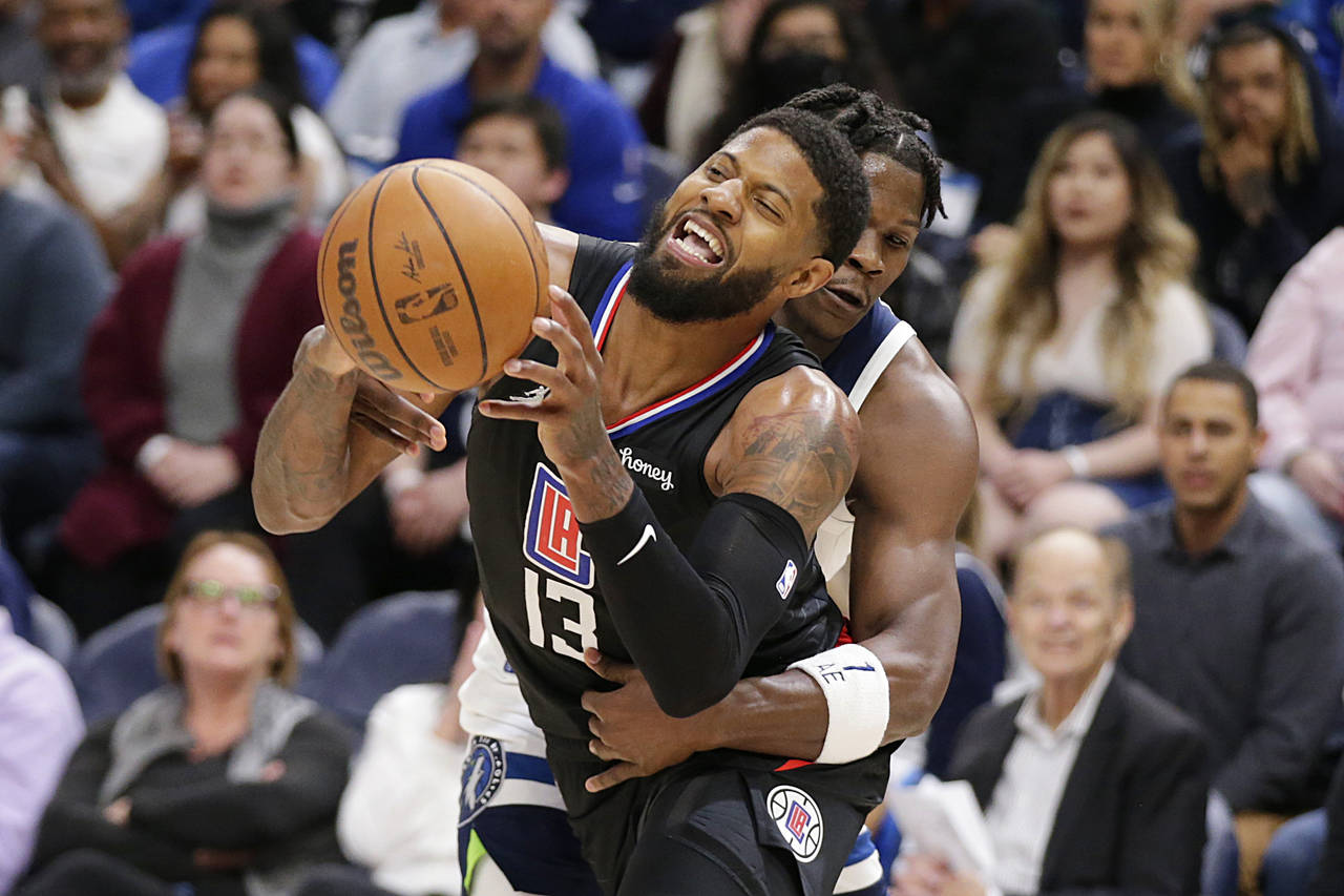 Los Angeles Clippers guard Paul George (13) is fouled by Minnesota Timberwolves forward Anthony Edw...