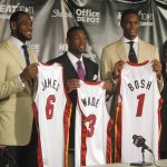 
              FILE - Miami Heat head coach Erik Spoelstra, from left, LeBron James (6), Dwyane Wade (3), Chris Bosh (1) and owner Micky Arison attend a news conference at the American Airlines Arena in Miami on Friday, July 9, 2010. (AP Photo/J. Pat Carter, File)
            