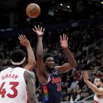 
              Philadelphia 76ers center Joel Embiid (21) misses on a shot between Toronto Raptors guard Fred VanVleet (23) and forward Pascal Siakam (43) during the second half of Game 3 of an NBA basketball first-round playoff series, Wednesday, April 20, 2022, in Toronto. (Nathan Denette/The Canadian Press via AP)
            