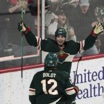
              Minnesota Wild's Kevin Fiala, top, celebrates his game-tying goal off San Jose Sharks goalie James Reimer in the third period of an NHL hockey game, Sunday, April 17, 2022, in St. Paul, Minn. The Wild won 5-4 in overtime where Fiala had an assist. (AP Photo/Jim Mone)
            