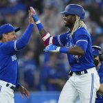 
              Toronto Blue Jays left fielder Raimel Tapia (15) celebrates his game winning sacrifice RBI with Blue Jays manager Charlie Montoyo (25) after defeating the Boston Red Sox in a baseball game, Tuesday, April 26, 2022 in Toronto. (Nathan Denette/The Canadian Press via AP)
            