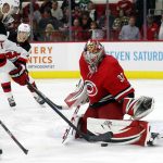 
              Carolina Hurricanes goaltender Antti Raanta (32) stops the shot of New Jersey Devils' Dougie Hamilton (7) during the first period of an NHL hockey game in Raleigh, N.C., Thursday, April 28, 2022. (AP Photo/Karl B DeBlaker)
            