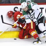 
              Dallas Stars centre Joe Pavelski (16) and Calgary Flames center Dillon Dube (29) battle along the boards for control of the puck during the third period of an NHL hockey game Thursday, April 21, 2022, in Calgary, Alberta. (Larry MacDougal/The Canadian Press via AP)
            