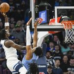 
              Minnesota Timberwolves guard Anthony Edwards, left, shoots over Memphis Grizzlies forward Xavier Tillman during the first half in Game 4 of an NBA basketball first-round playoff series Saturday, April 23, 2022, in Minneapolis. (AP Photo/Craig Lassig)
            