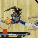 
              Villanova forward Brandon Slater, left, dunks past Kansas guard Christian Braun during the first half of a college basketball game in the semifinal round of the Men's Final Four NCAA tournament, Saturday, April 2, 2022, in New Orleans. (AP Photo/Brynn Anderson)
            
