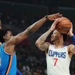 
              Los Angeles Clippers guard Amir Coffey tries to shoot as Oklahoma City Thunder forward Jaylen Hoard defends during the first half of an NBA basketball game Sunday, April 10, 2022, in Los Angeles. (AP Photo/Mark J. Terrill)
            