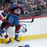 
              Colorado Avalanche defenseman Erik Johnson (6) checks New Jersey Devils defenseman Ryan Graves (33) into the boards during the first period of an NHL hockey game Thursday, April 14, 2022, in Denver. (AP Photo/Jack Dempsey)
            