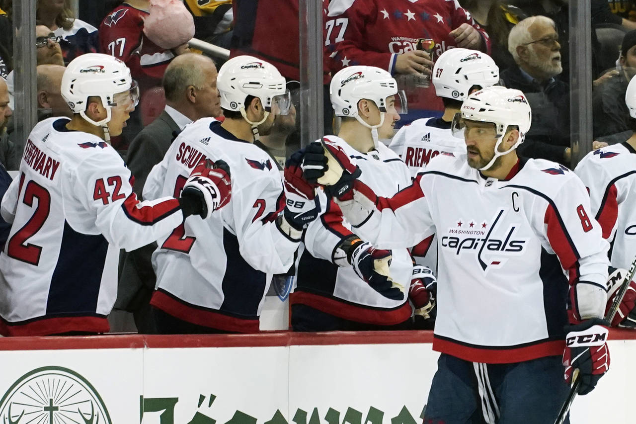 Washington Capitals' Alex Ovechkin (8) is greeted by teammates on the bench after scoring a power p...