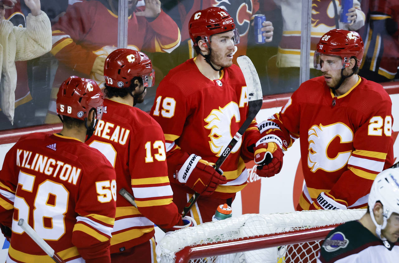 Calgary Flames' Matthew Tkachuk, second from right, celebrates his goal against the Arizona Coyotes...