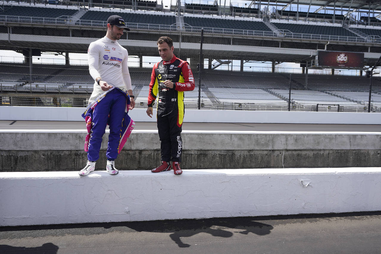 Alexander Rossi, left, and Delvin Defrancesco look at pit lane before testing at Indianapolis Motor...