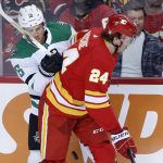 
              Dallas Stars center Joe Pavelski (16) battles for the puck with Calgary Flames right wing Brett Ritchie (24) during first-period NHL hockey game action in Calgary, Alberta, Thursday, April 21, 2022. (Larry MacDougal/The Canadian Press via AP)
            