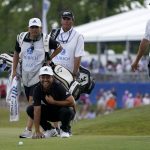 
              Xander Schauffele, left kneeling, laughs as he talks with Patrick Cantlay, right, and their caddies while lining up his putt on the 18th green during the final round of the PGA Zurich Classic golf tournament at TPC Louisiana in Avondale, La., Sunday, April 24, 2022. (AP Photo/Gerald Herbert)
            
