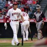 
              Los Angeles Angels' Shohei Ohtani, left, walks back to the dugout after striking out during the first inning of a baseball game against the Cleveland Guardians Monday, April 25, 2022, in Anaheim, Calif. (AP Photo/Mark J. Terrill)
            