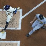
              Milwaukee Brewers' Kolten Wong scores past Pittsburgh Pirates starting pitcher Zach Thompson during the first inning of a baseball game Monday, April 18, 2022, in Milwaukee. Wo0ng scored on a wild pitch. (AP Photo/Morry Gash)
            