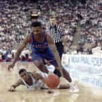 
              FILE - Kansas' Terry Brown, top, drives past North Carolina's Hubert Davis, bottom, during the second half of first semifinal NCAA college basketball game of the Final Four in Indianapolis, Saturday, March 30, 1991. North Carolina and Kansas are two of the most storied college basketball programs ever, yet they rarely play despite a share history that includes coaches Dean Smith, Larry Brown and Roy Williams. (AP Photo/Al Behrman, File)
            