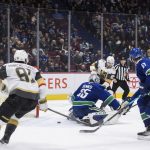 
              Vegas Golden Knights' Shea Theodore (27) scores against Vancouver Canucks goalie Thatcher Demko (35) during overtime in an NHL hockey game Sunday, April 3, 2022, in Vancouver, British Columbia. (Darryl Dyck/The Canadian Press via AP)
            
