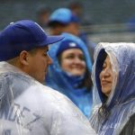 
              Los Angeles Dodgers wear ponchos during a rainstorm before the team's baseball game against the Minnesota Twins on Tuesday, April 12, 2022, in Minneapolis. (AP Photo/Nicole Neri)
            