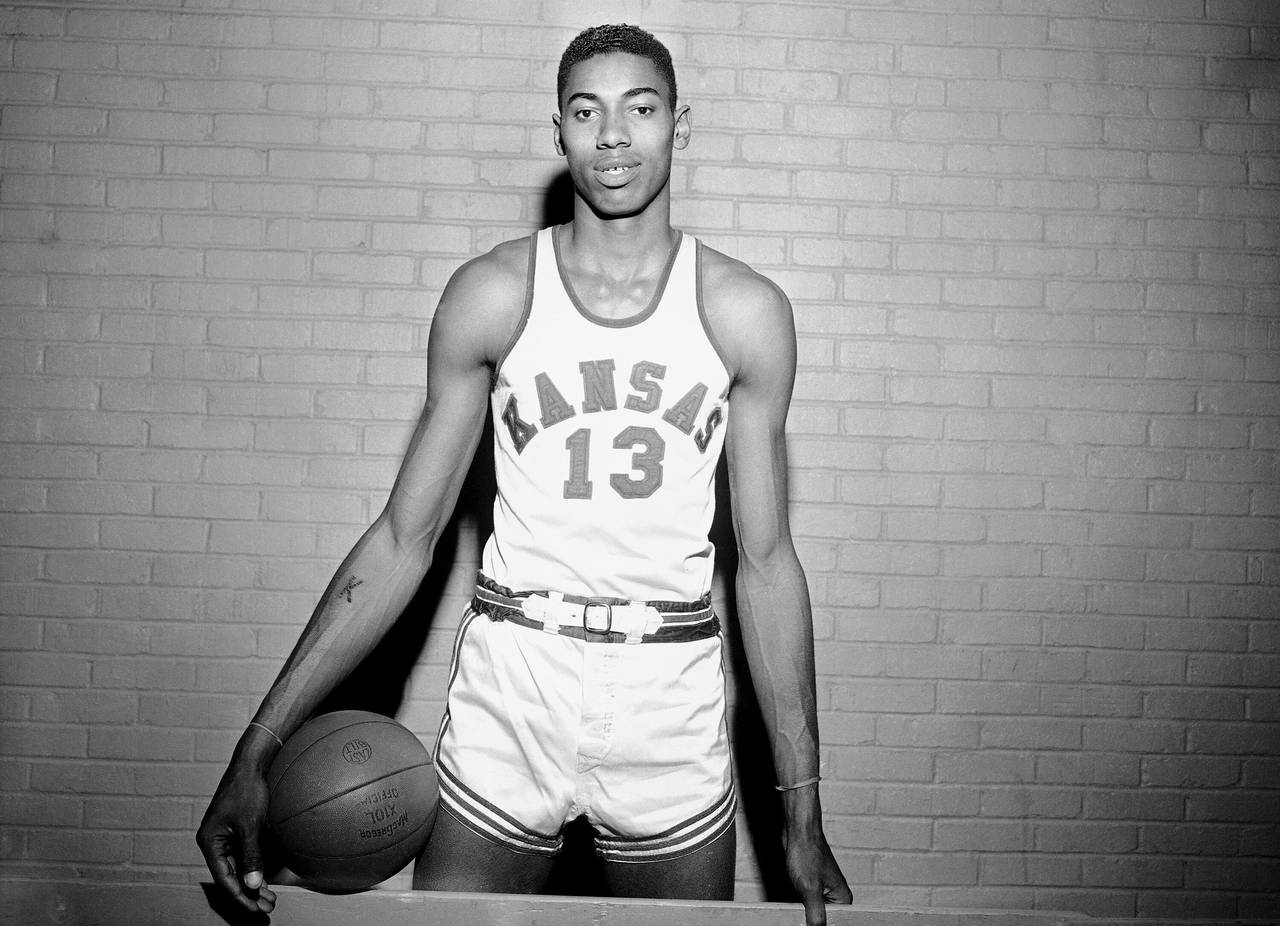 FILE - Wilt Chamberlain, Kansas' 7-foot basketball star, poses for a photo during a pause in practi...