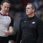 
              Referee Josh Tiven, left, confers with Los Angeles Lakers head coach Frank Vogel in the second half of an NBA basketball game Sunday, April 10, 2022, in Denver. (AP Photo/David Zalubowski)
            